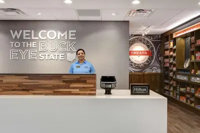 a man standing at a podium in a store at Hampton Inn & Suites Canal Winchester Columbus in Canal Winchester