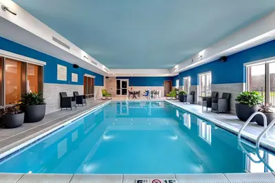 a pool in a hotel room with blue walls at Hampton Inn & Suites Canal Winchester Columbus in Canal Winchester