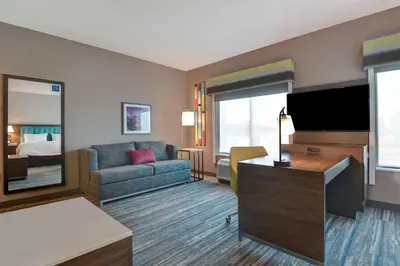 a hotel room with a couch and a television at Hampton Inn & Suites Canal Winchester Columbus in Canal Winchester