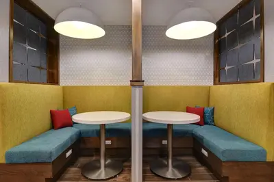a dining room with two tables and blue seats at Hampton Inn & Suites Canal Winchester Columbus in Canal Winchester