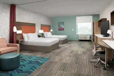 a hotel room with two beds and a desk at Home2 Suites By Hilton Columbus Polaris in Columbus
