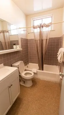 a bathroom with a toilet and a tub and a sink at Red Horse Motel Dayton Moraine in Dayton