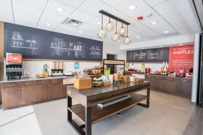 a kitchen with a counter in a restaurant at Hampton Inn Richwood Cincinnati South, KY in Richwood