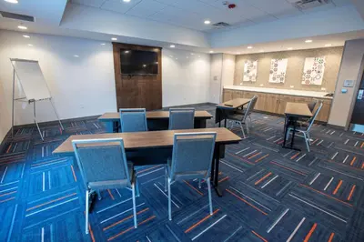 a conference room with tables and chairs and a screen at Hampton Inn Richwood Cincinnati South, KY in Richwood