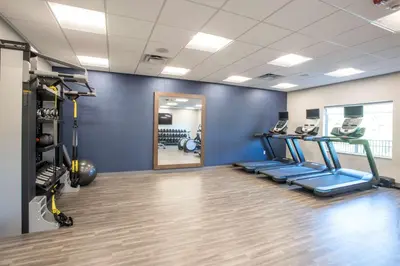 a gym with a treadmill and a mirror at Hampton Inn Richwood Cincinnati South, KY in Richwood