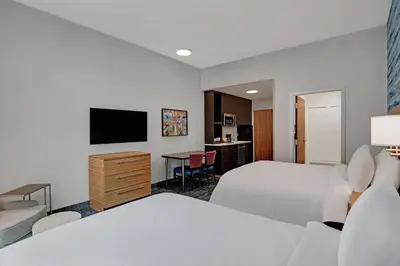 a hotel room with two beds and a flat screen tv at TownePlace Suites by Marriott Cincinnati Downtown in Cincinnati