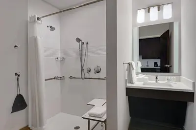 a white bathroom with a sink and a shower at TownePlace Suites by Marriott Cincinnati Downtown in Cincinnati