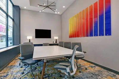 a conference room with a table and chairs and a tv at TownePlace Suites by Marriott Cincinnati Downtown in Cincinnati