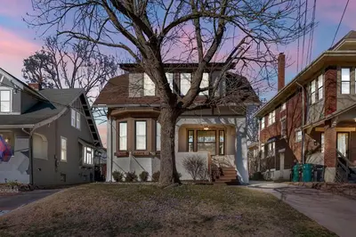 a house with a tree in the front yard at Oakley Square 3BR Charmer - Total Walkability home in Cincinnati