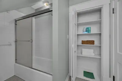 a shower with a glass door in a bathroom at Oakley Square 3BR Charmer - Total Walkability home in Cincinnati