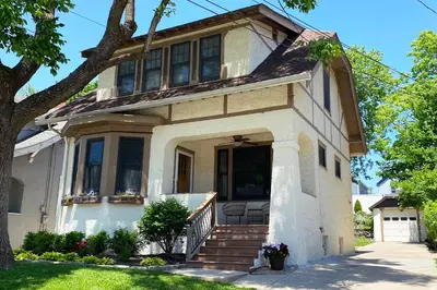 a white house with a porch and stairs at Oakley Square 3BR Charmer - Total Walkability home in Cincinnati