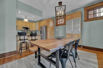 a kitchen and dining room with a wooden table and chairs at Oakley Square 3BR Charmer - Total Walkability home in Cincinnati