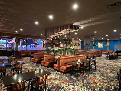 a restaurant with tables and chairs and a bar at Mountaineer Casino Resort in New Cumberland