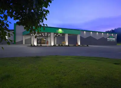 a large building with lights on it at night at Mountaineer Casino Resort in New Cumberland