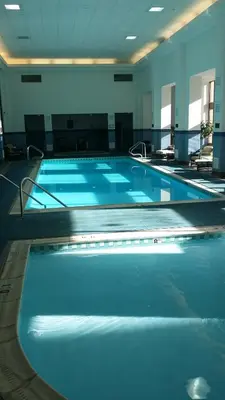 a large swimming pool with blue water in a building at Mountaineer Casino Resort in New Cumberland