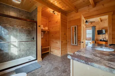 a large bathroom with a shower and a sink at Family Friendly ~ Hocking Hills Cabin ~ Close to Caves, w/Wifi in South Bloomingville