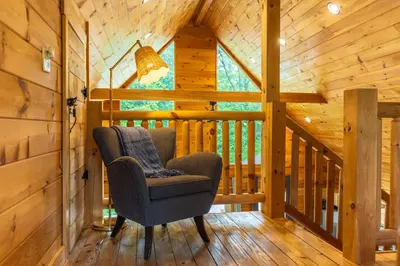 a room with a chair in a cabin at Family Friendly ~ Hocking Hills Cabin ~ Close to Caves, w/Wifi in South Bloomingville