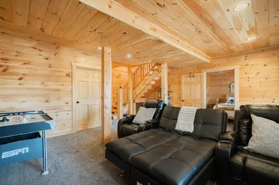 a living room with leather furniture in a log cabin at Family Friendly ~ Hocking Hills Cabin ~ Close to Caves, w/Wifi in South Bloomingville