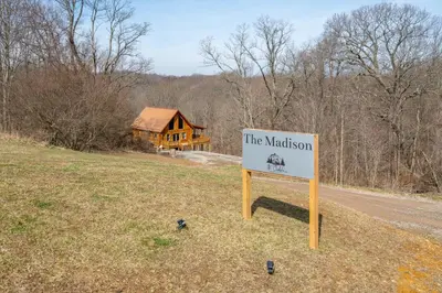 a sign on the side of a road in front of a house at Family Friendly ~ Hocking Hills Cabin ~ Close to Caves, w/Wifi in South Bloomingville