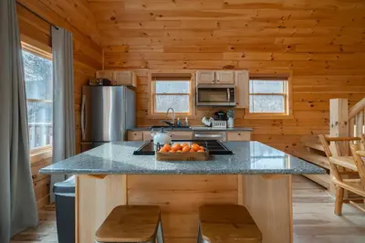 a kitchen with a counter with a bowl of fruit on it at Family Friendly ~ Hocking Hills Cabin ~ Close to Caves, w/Wifi in South Bloomingville
