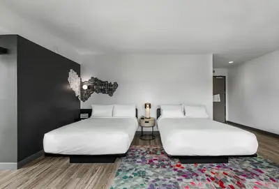 two beds in a room with a rug at Aloft Columbus Easton in Columbus