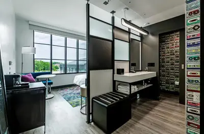 a dressing room with a sink and a mirror at Aloft Columbus Easton in Columbus