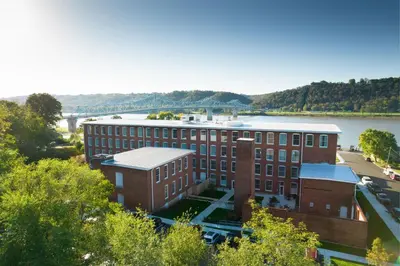 an aerial view of a brick building next to a river at Fairfield Inn & Suites Madison Historic Eagle Cotton Mill in Madison