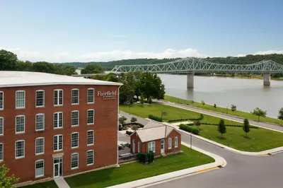 an aerial view of a brick building with a bridge in the background at Fairfield Inn & Suites Madison Historic Eagle Cotton Mill in Madison