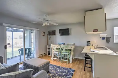a kitchen and living room with a table and chairs at Serene Abode on Lake Erie about 9 Miles to Oak Harbor in Sand Beach