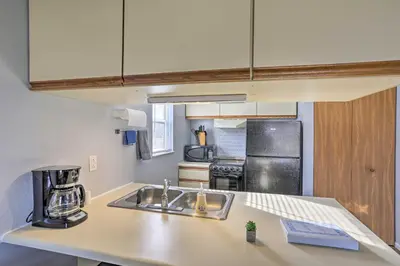 a kitchen with a sink and a refrigerator at Serene Abode on Lake Erie about 9 Miles to Oak Harbor in Sand Beach