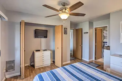 a bedroom with a bed and a ceiling fan at Serene Abode on Lake Erie about 9 Miles to Oak Harbor in Sand Beach