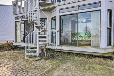 a house with a spiral staircase on the side of it at Serene Abode on Lake Erie about 9 Miles to Oak Harbor in Sand Beach