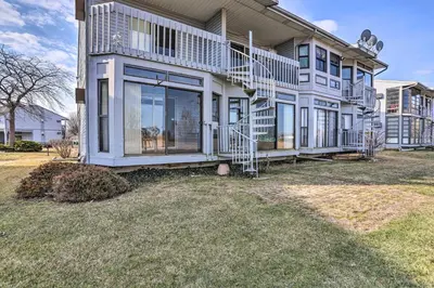 a large house with a balcony and a yard at Serene Abode on Lake Erie about 9 Miles to Oak Harbor in Sand Beach