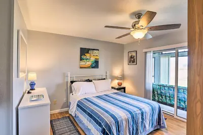 a bedroom with a bed and a ceiling fan at Serene Abode on Lake Erie about 9 Miles to Oak Harbor in Sand Beach