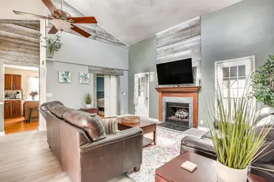 a living room with a leather couch and a fireplace at Grill, Yard and Fire Pit Huntsville Gem with Views in Huntsville
