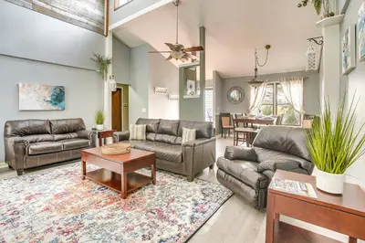 a living room with couches and a table at Grill, Yard and Fire Pit Huntsville Gem with Views in Huntsville