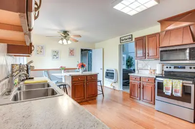 a kitchen with wooden cabinets and stainless steel appliances at Grill, Yard and Fire Pit Huntsville Gem with Views in Huntsville
