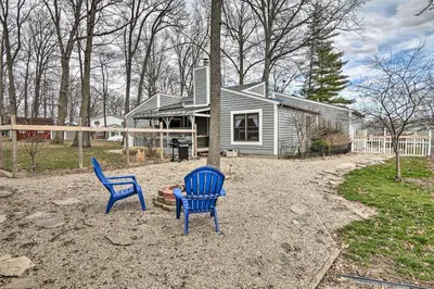 two blue chairs sitting in front of a house at Grill, Yard and Fire Pit Huntsville Gem with Views in Huntsville