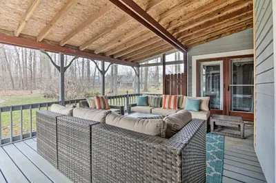 a screened in porch with a couch on a deck at Grill, Yard and Fire Pit Huntsville Gem with Views in Huntsville