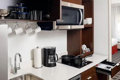 a kitchen with a sink and a microwave at TownePlace Suites by Marriott Ironton in Ironton