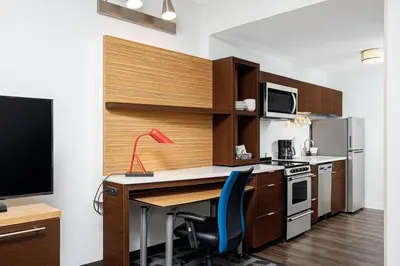 a kitchen with a desk with a red lamp on it at TownePlace Suites by Marriott Ironton in Ironton