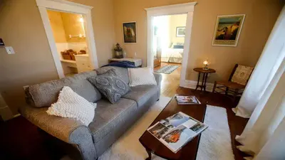 a living room with a couch and a table at Chessie Room in Huntington