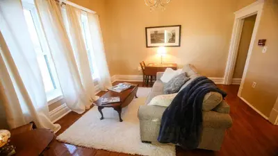 a living room with a couch and a table at Chessie Room in Huntington
