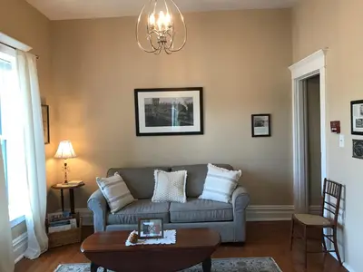 a living room with a couch and a table at Chessie Room in Huntington