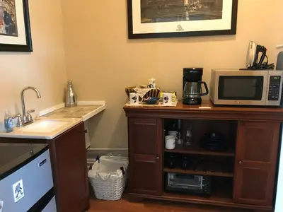 a kitchen with a counter with a microwave and a sink at Chessie Room in Huntington