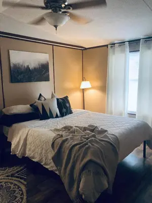 a bedroom with a bed and a ceiling fan at Convenient and Spacious home in Stanton, Ky in Stanton