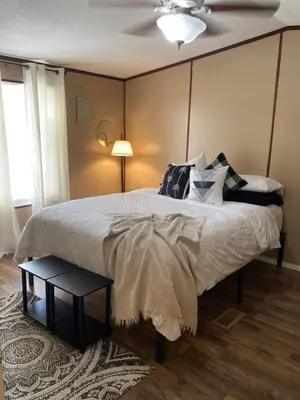 a bedroom with a large bed with a ceiling at Convenient and Spacious home in Stanton, Ky in Stanton