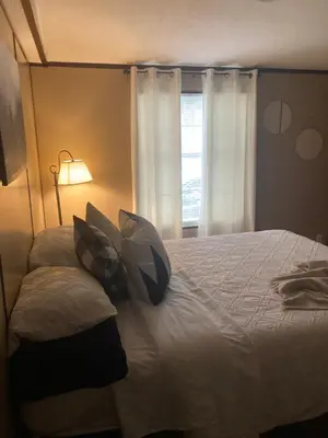 a bedroom with a bed with pillows and a window at Convenient and Spacious home in Stanton, Ky in Stanton