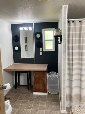 a bathroom with a sink and a mirror at Convenient and Spacious home in Stanton, Ky in Stanton