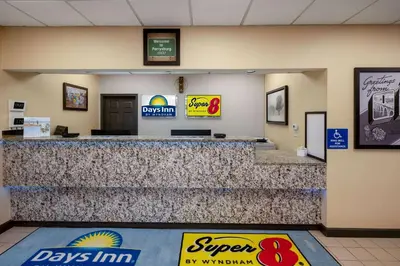 a lobby of a days inn with a large counter at Days Inn by Wyndham Perrysburg Toledo in Perrysburg